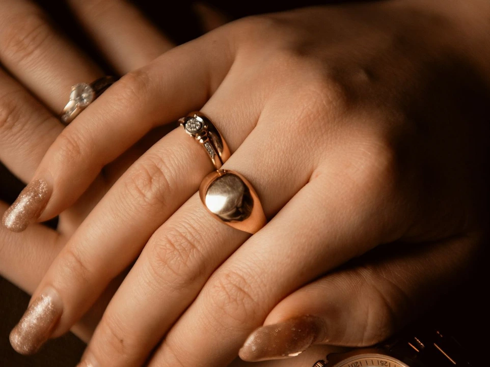 A woman's hands with rings and a watch