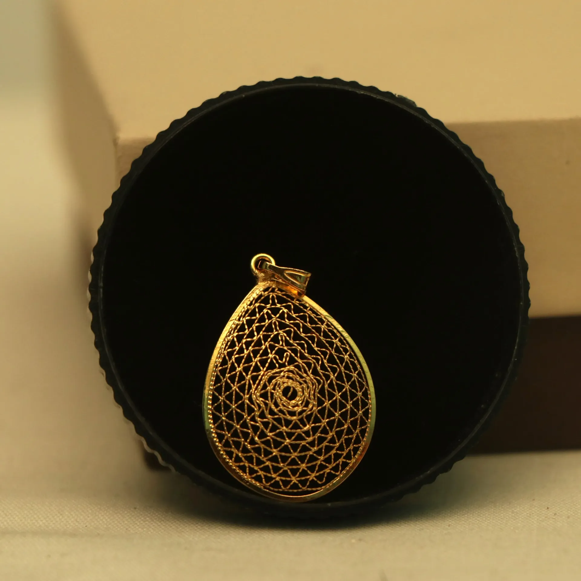 Arihant Spiral Mesh Gold-Finish Pear Locket